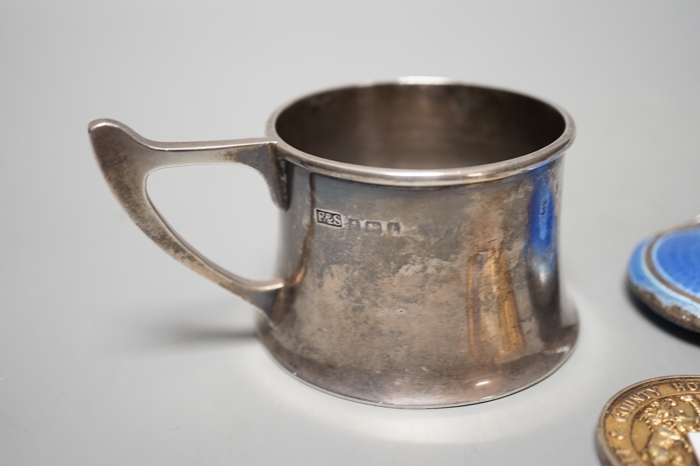 A George V silver cup holder, Birmingham, 1918, a silver and enamel Cardiff & County Horticultural Society medallion and a silver and enamel compact(a.f.)